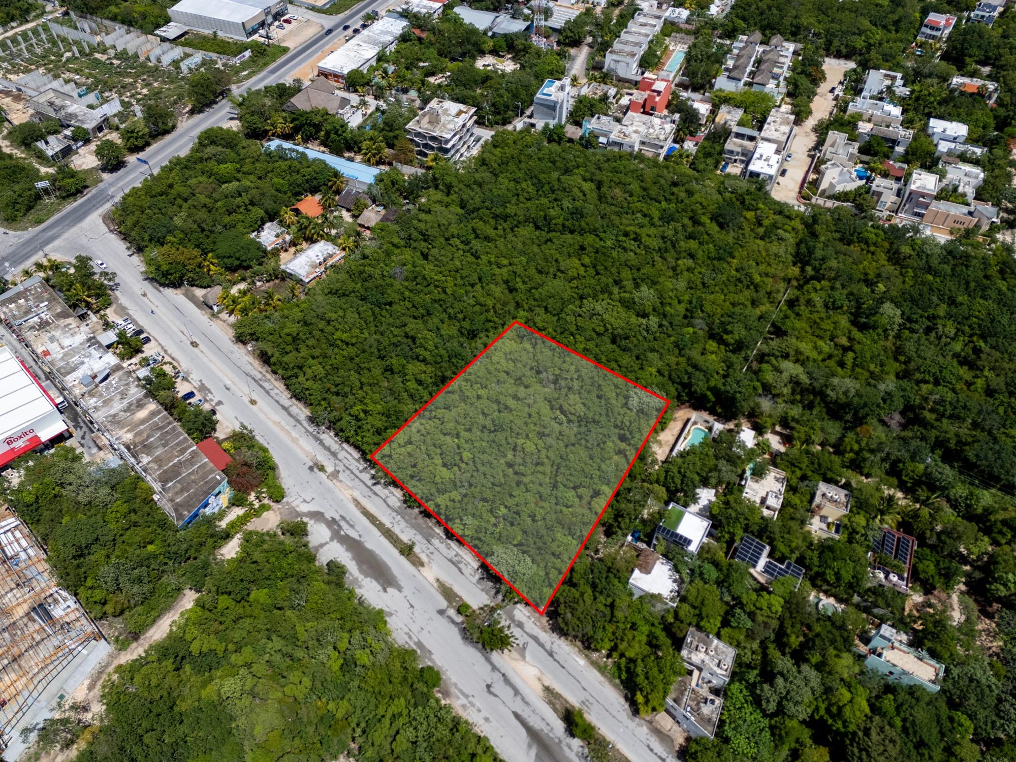 Oblique drone view showing the lot along the avenue with surrounding buildings